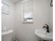 Cozy half bathroom with white walls, a window, and a corner sink at 1712 Azalea Ct # A, Oldsmar, FL 34677