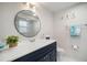 Chic bathroom with modern vanity, lighting, and a decorative round mirror at 1712 Azalea Ct # A, Oldsmar, FL 34677