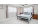 Bright bedroom with white tile flooring, ceiling fan, and large windows with natural light at 1712 Azalea Ct # A, Oldsmar, FL 34677