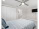 Spacious bedroom includes a ceiling fan, mounted TV, and a closet with sliding doors at 1712 Azalea Ct # A, Oldsmar, FL 34677