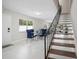 Welcoming entryway features a dining area and a staircase with metal railing at 1712 Azalea Ct # A, Oldsmar, FL 34677