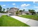 Two-story home with a long driveway, carport and well-maintained lawn at 1712 Azalea Ct # A, Oldsmar, FL 34677