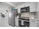 Well-lit kitchen features stainless steel appliances and granite countertops at 1712 Azalea Ct # A, Oldsmar, FL 34677