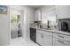 Efficient kitchenette with granite counters, gray cabinets, and updated appliances at 1712 Azalea Ct # A, Oldsmar, FL 34677