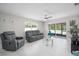 Bright living room featuring modern furniture and access to the screened-in patio at 1712 Azalea Ct # A, Oldsmar, FL 34677