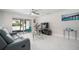 Bright living room featuring modern furniture and access to the screened-in patio at 1712 Azalea Ct # A, Oldsmar, FL 34677