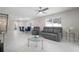 An open-concept living space, adjacent to a dining area, with a ceiling fan at 1712 Azalea Ct # A, Oldsmar, FL 34677