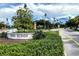 Scenic street view of Davis Islands sign and surroundings with lush landscaping and palm trees under a partly cloudy sky at 1712 Azalea Ct # A, Oldsmar, FL 34677