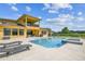 The back exterior shows a large pool with a spa and covered patio at 17914 Howsmoor Pl, Lutz, FL 33559
