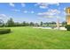 Vast backyard with a view of the pool, providing ample space for recreation and entertaining, trimmed hedges and lush lawn at 17914 Howsmoor Pl, Lutz, FL 33559