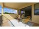 Outdoor balcony with seating, rug, and a sliding glass door leading to the game room at 17914 Howsmoor Pl, Lutz, FL 33559