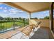 A relaxing balcony with a beautiful view of a pool and yard at 17914 Howsmoor Pl, Lutz, FL 33559