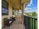A covered outdoor balcony provides an area to sit and view the community at 17914 Howsmoor Pl, Lutz, FL 33559