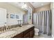 Bathroom featuring double sinks, granite countertops, and a shower-tub combination at 17914 Howsmoor Pl, Lutz, FL 33559