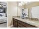 Bathroom featuring a dual sink vanity with granite countertops, storage and lighting at 17914 Howsmoor Pl, Lutz, FL 33559