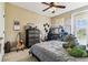 Comfortable bedroom with natural light, neutral colors, and a ceiling fan at 17914 Howsmoor Pl, Lutz, FL 33559