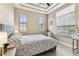 Bedroom with patterned bedspread, neutral walls, and ample natural light at 17914 Howsmoor Pl, Lutz, FL 33559