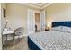 Bedroom with desk, chair, and French doors, offering a serene and functional space at 17914 Howsmoor Pl, Lutz, FL 33559
