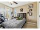 Well-lit bedroom with a window and a door out to a balcony at 17914 Howsmoor Pl, Lutz, FL 33559