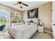 Bedroom offers natural light and a ceiling fan with light, plus a decorative black and white picture at 17914 Howsmoor Pl, Lutz, FL 33559