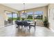 Bright dining room with views of the lush backyard and pool area at 17914 Howsmoor Pl, Lutz, FL 33559