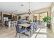 Open dining area with view to the outdoor seating area at 17914 Howsmoor Pl, Lutz, FL 33559