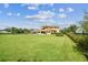 Landscape view of a beautiful backyard, showcasing the manicured lawn, pool, and the impressive home exterior at 17914 Howsmoor Pl, Lutz, FL 33559