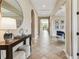 Inviting foyer features a table with decor, and view to the living area with decorative columns at 17914 Howsmoor Pl, Lutz, FL 33559