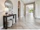 Welcoming foyer featuring decorative table and decor, with a view of the living spaces at 17914 Howsmoor Pl, Lutz, FL 33559