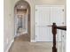 Upstairs hallway with an arched doorway and a linen closet at 17914 Howsmoor Pl, Lutz, FL 33559