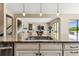 Granite island featuring a sink and pendant lights overlooking the open-concept living area at 17914 Howsmoor Pl, Lutz, FL 33559