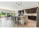 Open concept kitchen with large island and bar stool seating at 17914 Howsmoor Pl, Lutz, FL 33559
