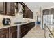 Gourmet kitchen featuring granite countertops, stainless steel appliances, and dark wood cabinets at 17914 Howsmoor Pl, Lutz, FL 33559