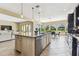 Open-concept kitchen with granite island, stainless steel appliances, and a view of the dining area at 17914 Howsmoor Pl, Lutz, FL 33559