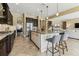 Kitchen with granite island, stainless steel appliances, and adjacent living room at 17914 Howsmoor Pl, Lutz, FL 33559