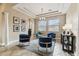 Cozy living room features three accent chairs, a center table, and natural light from large windows at 17914 Howsmoor Pl, Lutz, FL 33559