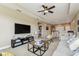 A spacious living room features a cozy seating area, complemented by a large TV and a comfortable grey sofa at 17914 Howsmoor Pl, Lutz, FL 33559