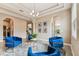 Bright living room featuring multiple archways, tile floor, and 4 stylish blue chairs at 17914 Howsmoor Pl, Lutz, FL 33559