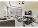 A cozy living room with neutral tones, including a plush grey couch and large windows, creating a welcoming atmosphere at 17914 Howsmoor Pl, Lutz, FL 33559