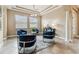 Inviting living room with accent chairs, overhead lighting, and views to the outdoors at 17914 Howsmoor Pl, Lutz, FL 33559