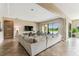Spacious living room with a large sectional, tile flooring, and sliding glass doors to the backyard at 17914 Howsmoor Pl, Lutz, FL 33559