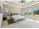 Large main bedroom with trey ceiling, ample natural light, and view of backyard at 17914 Howsmoor Pl, Lutz, FL 33559