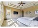 Bright bedroom with ceiling fan, natural light, and direct access to outside at 17914 Howsmoor Pl, Lutz, FL 33559