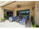 Covered patio with comfortable seating area, ceiling fan, and views of the pool at 17914 Howsmoor Pl, Lutz, FL 33559