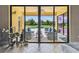 Covered outdoor patio with comfortable seating overlooks a sparkling pool and lush landscaping at 17914 Howsmoor Pl, Lutz, FL 33559