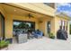 A covered patio complete with outdoor seating, a ceiling fan, and seamless access to the pool area at 17914 Howsmoor Pl, Lutz, FL 33559