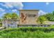 Cordoba Estates sign in stone with lush landscaping, blue skies with puffy white clouds at 17914 Howsmoor Pl, Lutz, FL 33559
