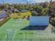 Aerial view of a well-maintained sport court, perfect for basketball and other recreational activities at 17914 Howsmoor Pl, Lutz, FL 33559