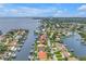 Stunning aerial view of waterfront homes with boat docks on a sunny day near a bay, showcasing the coastal lifestyle at 1960 Kansas Ne Ave, St Petersburg, FL 33703