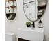 Stylish bathroom with modern fixtures, a decorative mirror, and floating wood shelves at 1960 Kansas Ne Ave, St Petersburg, FL 33703